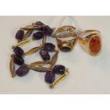 A 14ct gold necklace set with amethyst beads at intervals, 12g, a 14ct gold ring set amber, size