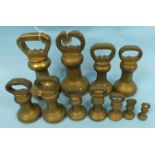 Eleven brass bell-shaped weights, 23cm - 7cm, (11).