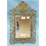 A pierced-brass-framed strut mirror, 46 x 28cm.