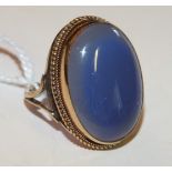 A large dress ring collet set a blue chalcedony cabochon in 9ct gold mount, size N 1/2, 7.6g.