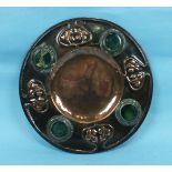 An Art Nouveau circular heated copper dish with embossed decoration and applied Ruskin-style ceramic