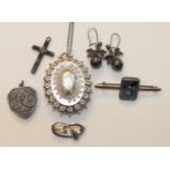 An Edwardian silver locket on later chain, another silver locket with bicycle motif, a silver