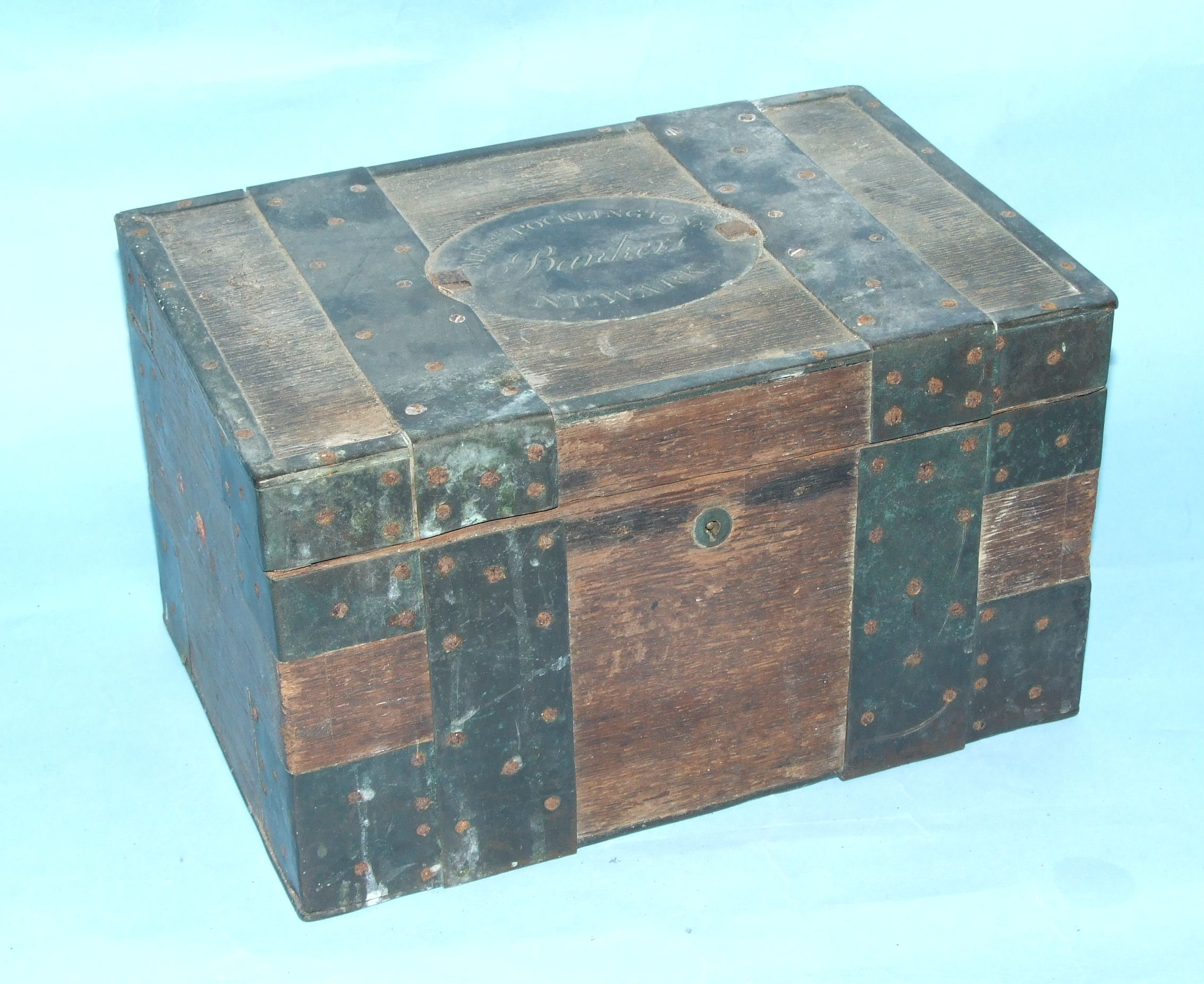 A late-18th/early-19th century hardwood strong box with overall brass bindings and an oval plaque