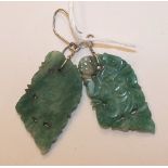 A pair of carved jade plaques mounted as earrings, with wire fish hook fittings, plaques 4.4cm long,