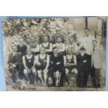 An early-20th century photograph of a Plymouth water polo team, swimmers and coaches, posing with