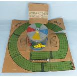 A Spira Chase Racing Game comprising a die cast carousel with winder and race course on card which