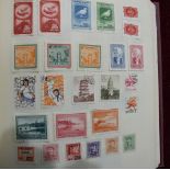 An All-World collection of stamps in a Devon album, including China.