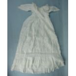 An Edwardian child's dress with hand-stitched broderie Anglaise panel and flounces, an ivory satin