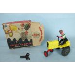 A DCMT Tricky Tractor with yellow body, C/W motor and jointed metal driver, in original box, (box