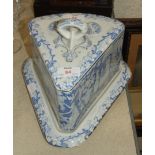 A late-19th century blue and white wedge shape cheese dish and cover decorated with figures within a