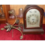 An Edwardian hardwood arched mantel clock with silvered dial, signed 'Wales and McCulloch', with