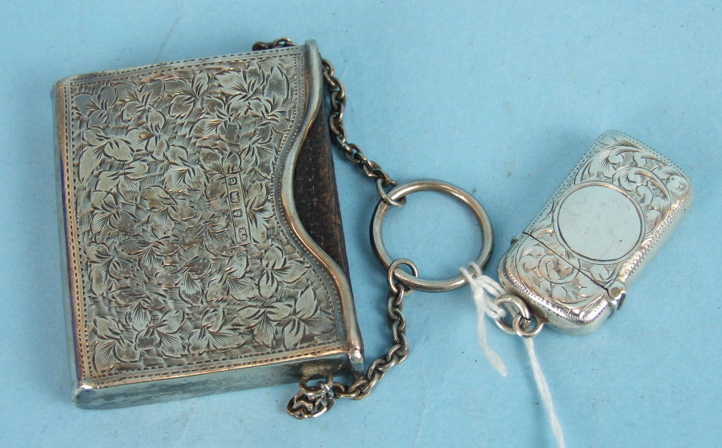 An Edwardian miniature silver book sleeve with carrying chain containing a leather bound Book of