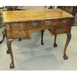 A cross-banded walnut dressing table in the early-18th century style, the rectangular top above an