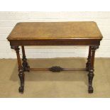 A Victorian figured walnut card table, the fold-over rectangular top raised on fluted and turned