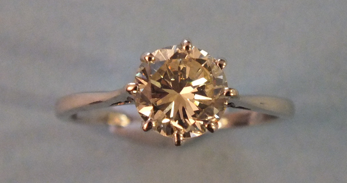 A certificated solitaire diamond ring claw set a brilliant cut diamond of 1.71cts in 18ct gold and