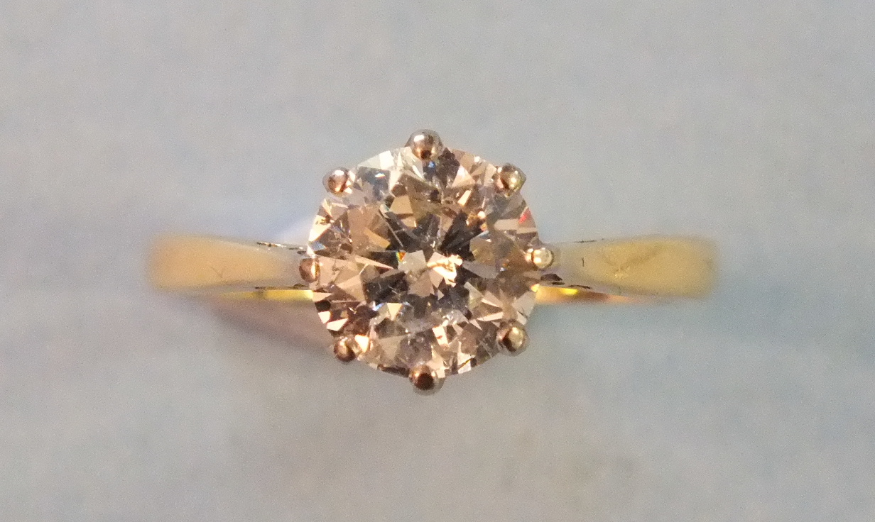 A solitaire diamond ring claw-set a brilliant-cut diamond of approximately 1.2cts, in 18ct yellow