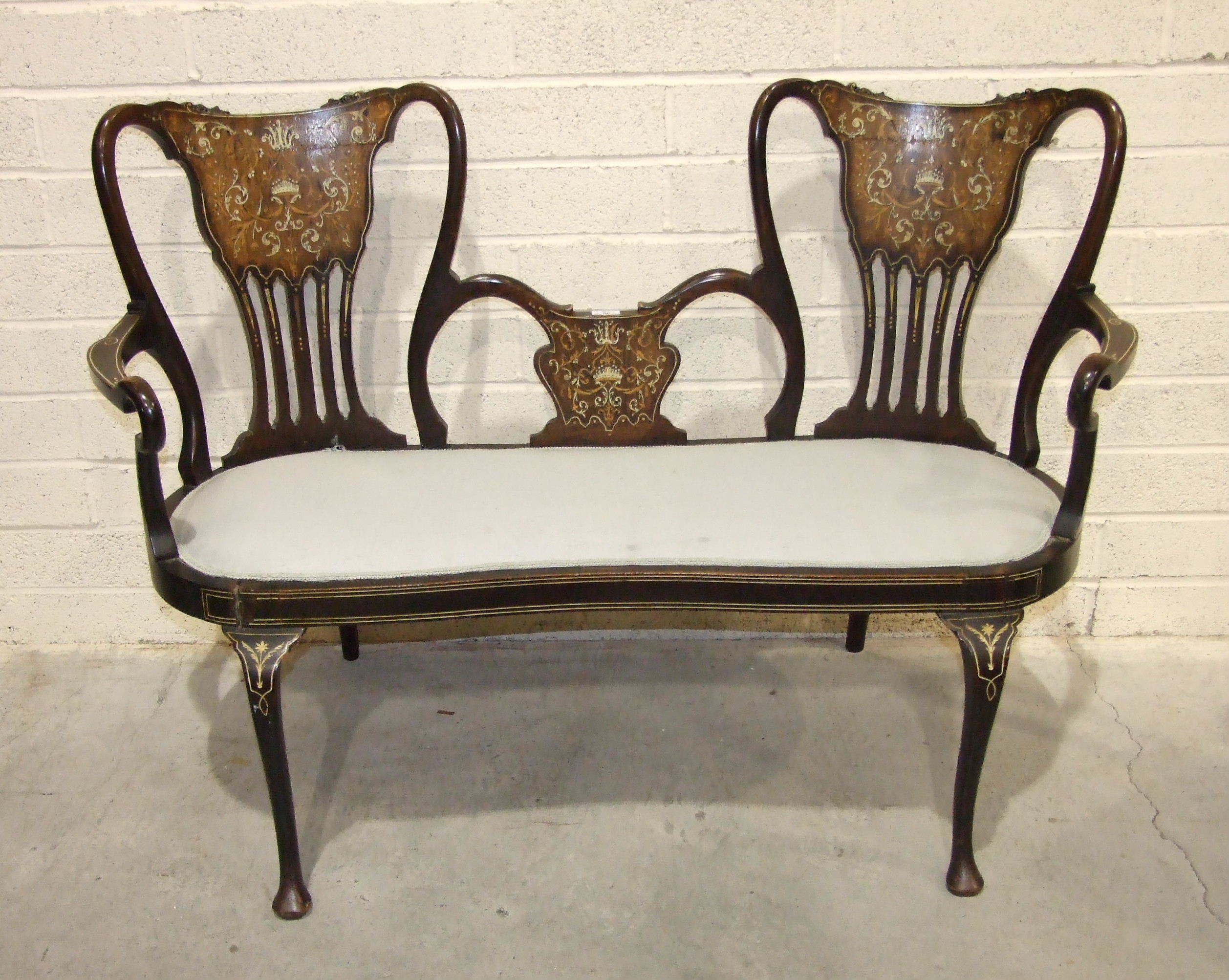 An Edwardian boxwood and ivory inlaid two-seat hall chair on cabriole legs, (in need of restoration)