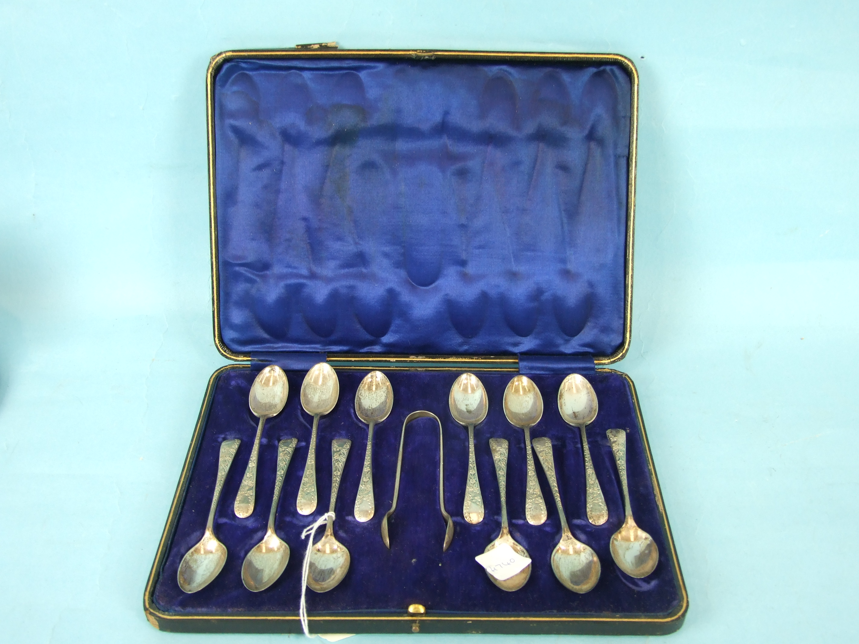 A cased set of twelve silver teaspoons and sugar tongs, Sheffield 1912.