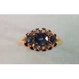 An Edwardian 18ct gold ring set three sapphires and seven rose cut diamonds, (one setting vacant)