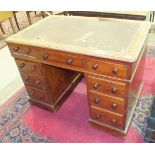 A late Victorian mahogany knee-hole pedestal writing desk fitted with three frieze drawers and six