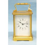 A 19th century French brass carriage alarm timepiece, with damaged white dial and bell striking