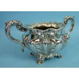 A Victorian two-handled silver sugar bowl, the lobed foliate chased body with leaf capped handles on