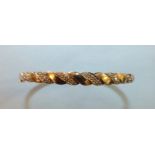 A 9ct gold hinged bangle of rope-twist design set 8/8-cut diamond points, 9g.