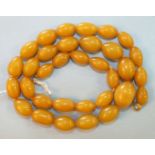 A string of yellow amber-type Bakelite graduated beads.