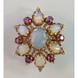 An opal and ruby brooch/pendant claw-set a cluster of seven oval water opals and six round-cut