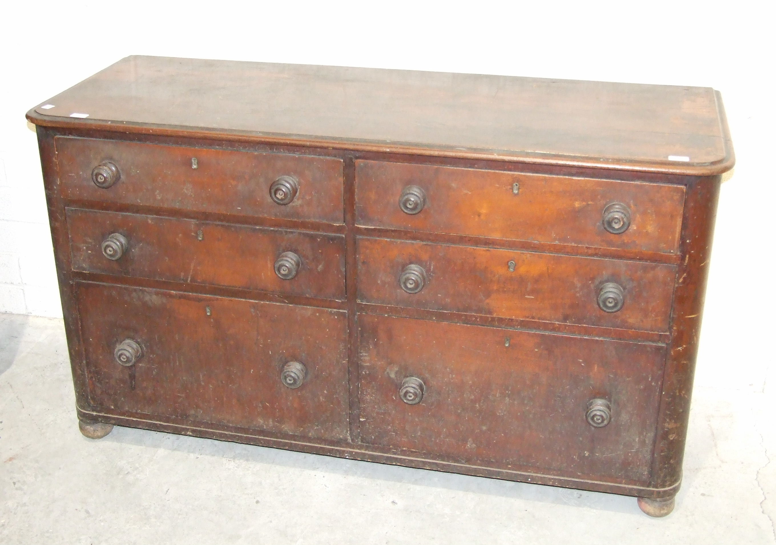 An early 19th century mahogany storage chest of six graduated drawers in two banks with turned