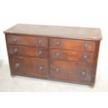 An early 19th century mahogany storage chest of six graduated drawers in two banks with turned