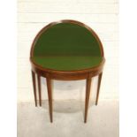 A Georgian mahogany inlaid fold-over card table, the circular top on square tapered legs, 92cm