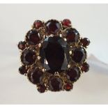 A garnet cluster ring claw and collet-set seventeen garnets, in 9ct gold mount, size I½, 5g.