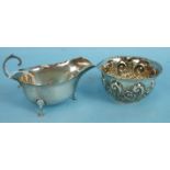 An embossed silver sugar bowl, Sheffield 1903 and a plain silver sauce boat, Birmingham 1938, (2)