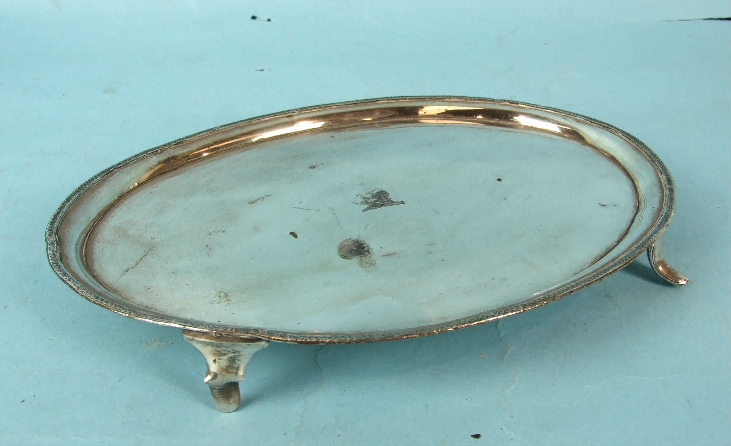 An early Sheffield plate letter tray with beaded border on tab feet, bearing the Eliot crest, 26cm.