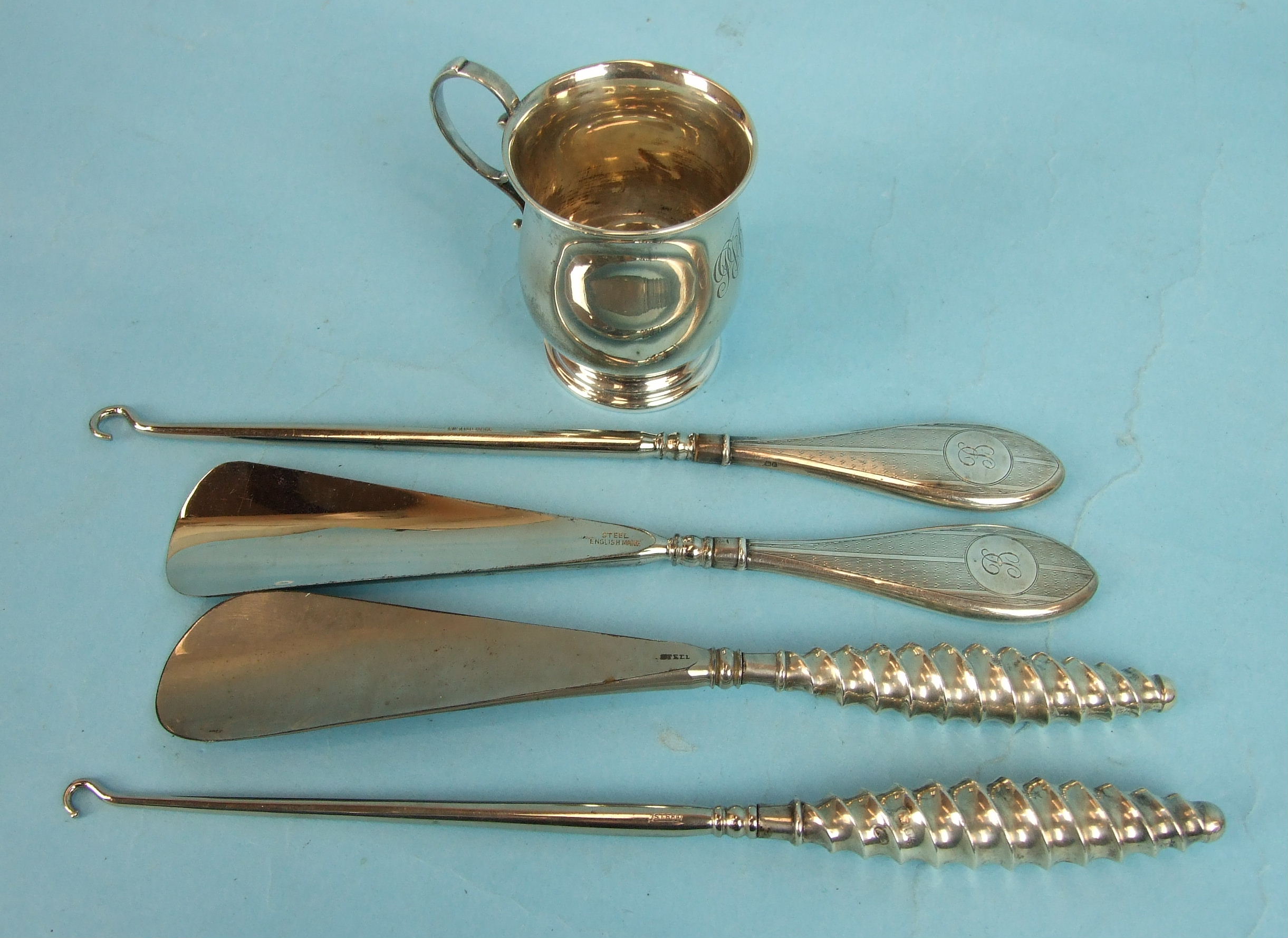 A silver spiral-handled button hook and shoe horn, Birmingham 1892, a later pair, Birmingham 1929