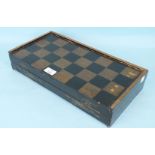 A mahogany three-division tea caddy, a lacquered back gammon board, bone chess pieces and ivory