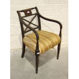 A late-Georgian mahogany carver chair with reeded frame and upholstered seat, on turned legs.