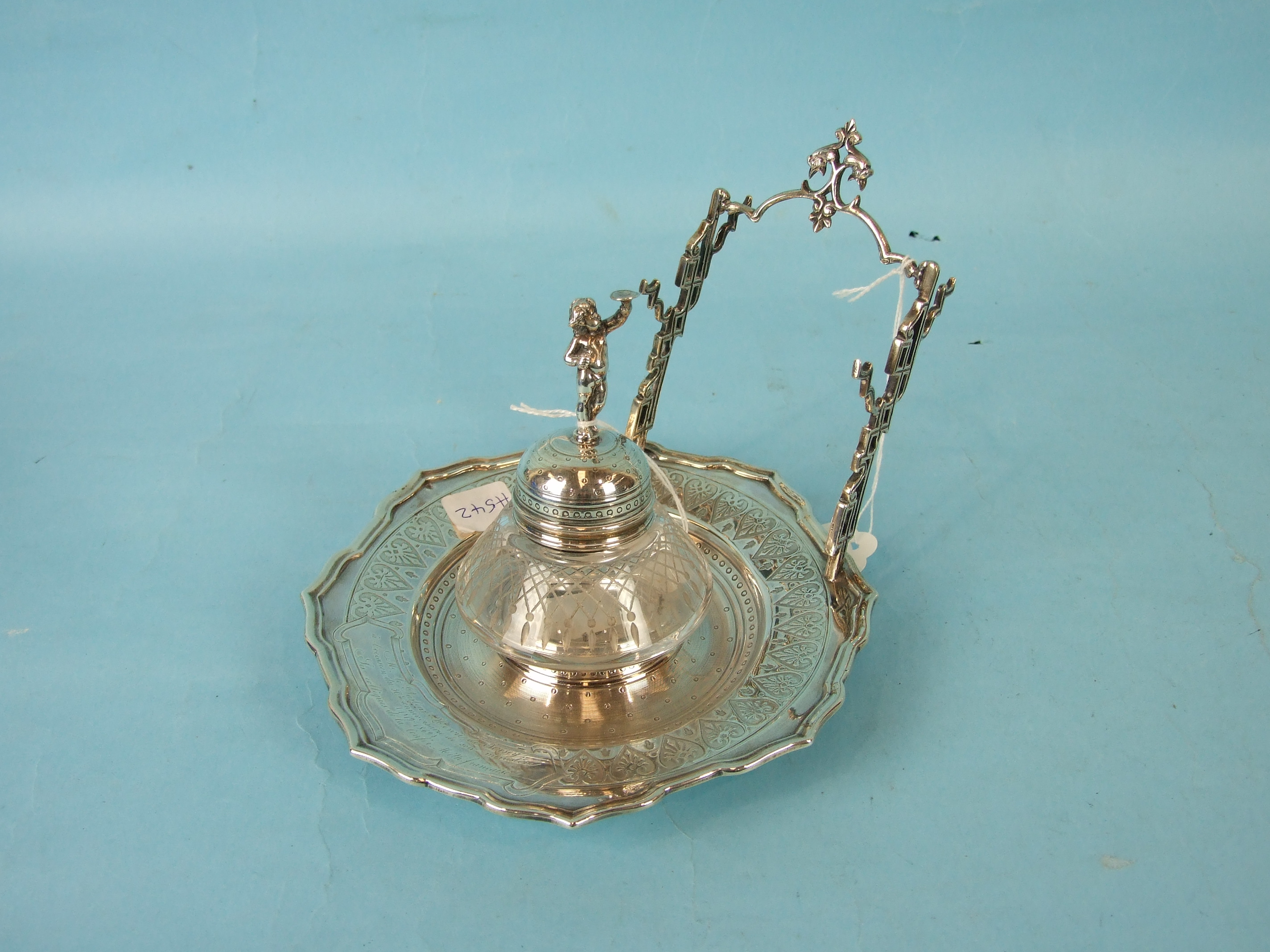 A Continental silver pen and ink stand, the finialed cut glass well on a circular engraved footed