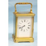 A 19th century lacquered brass carriage clock with white enamelled dial and gong striking