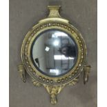 A 19th century gilt framed girandole, the circular hall mirror frame with convex plate and two