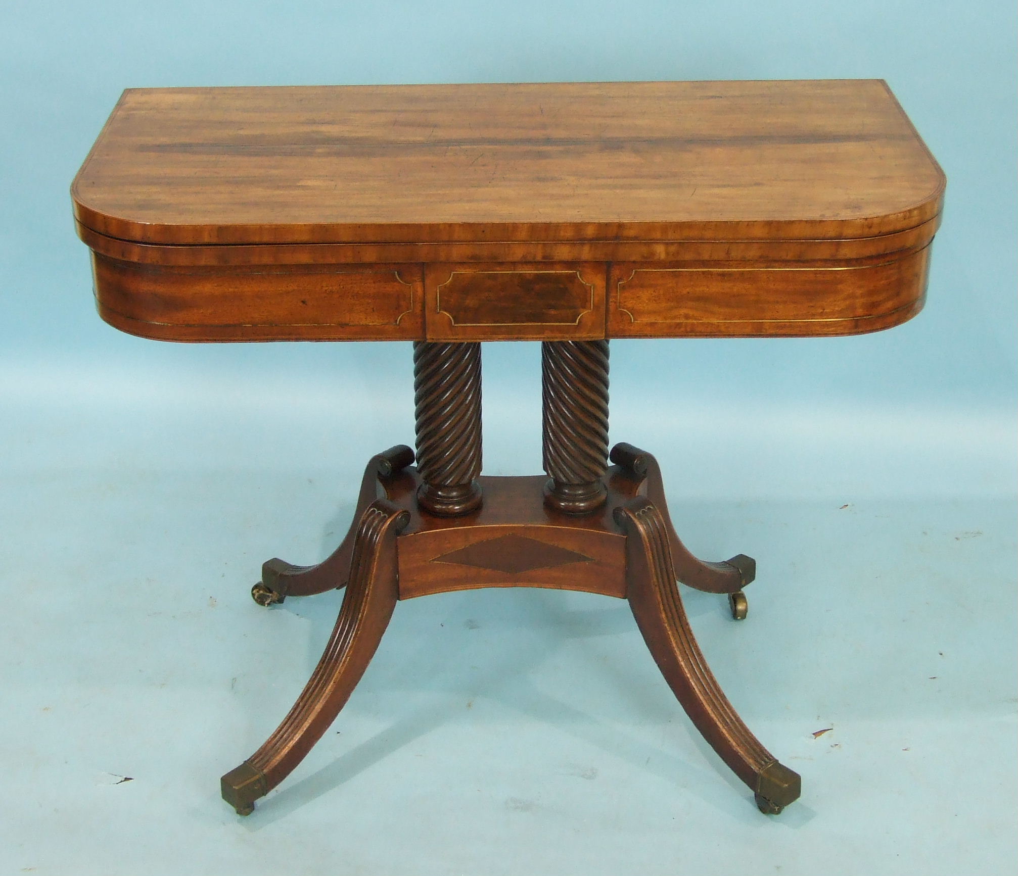 A Regency mahogany fold-over card table, the baize-lined top above a brass-inlaid frieze, raised - Image 2 of 2