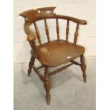 An early 20th century elm and beech captain's chair.