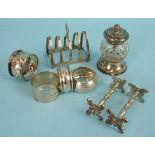 A pair of Victorian silver knife rests, London 1837, a modern toast rack, four napkin rings and a