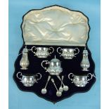 An Edwardian seven-piece cruet set in fitted box with acanthus embossed decoration and scroll