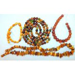 A string of small multi-coloured amber-type beads, a string of amber chips and a quantity of small