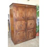 A George IV mahogany two-door wardrobe press, the cornice above a pair of panelled doors,