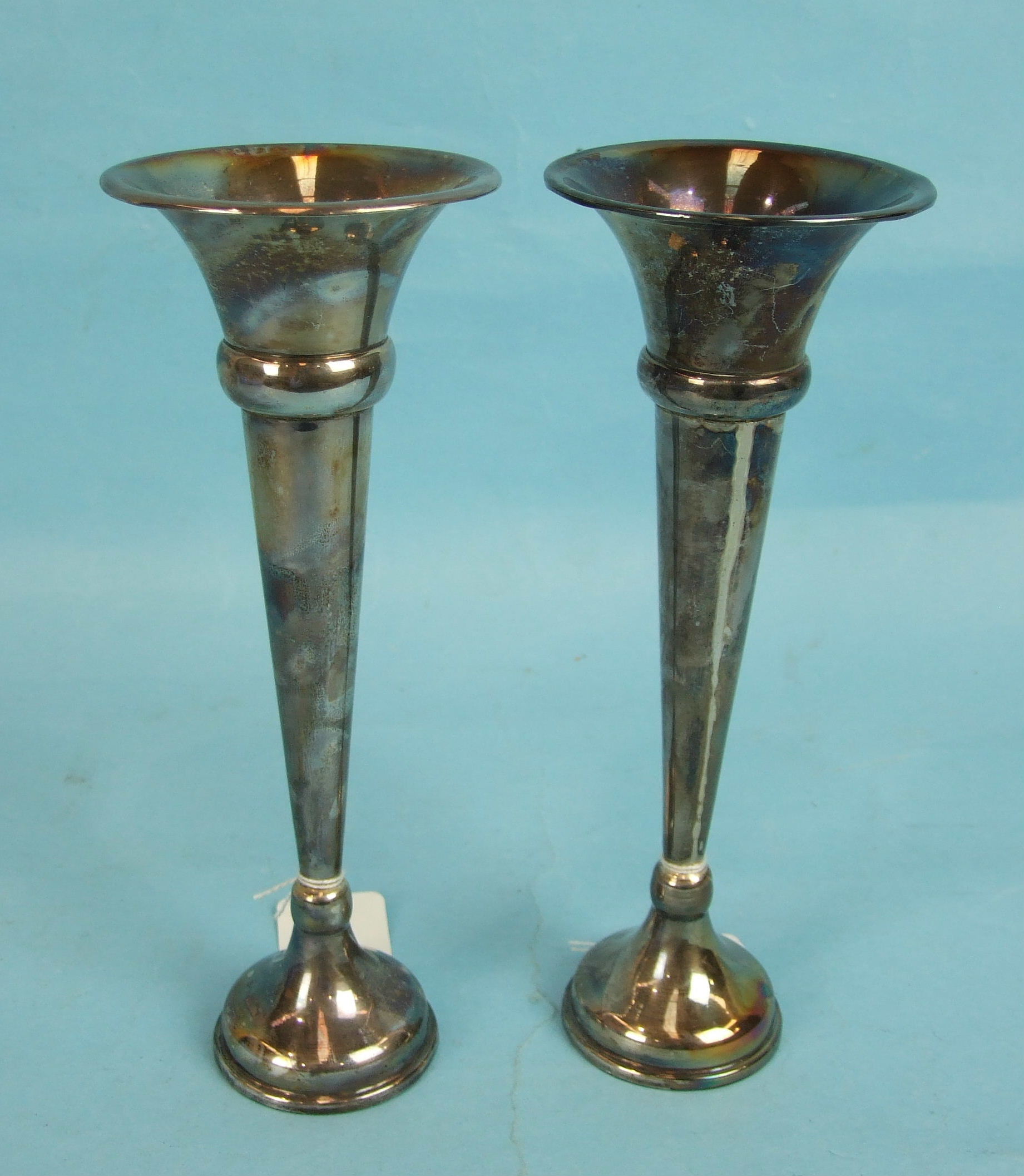 Two similar silver spill vases with knopped stems, 23cm high, London 1926, (loaded), (one a/f).