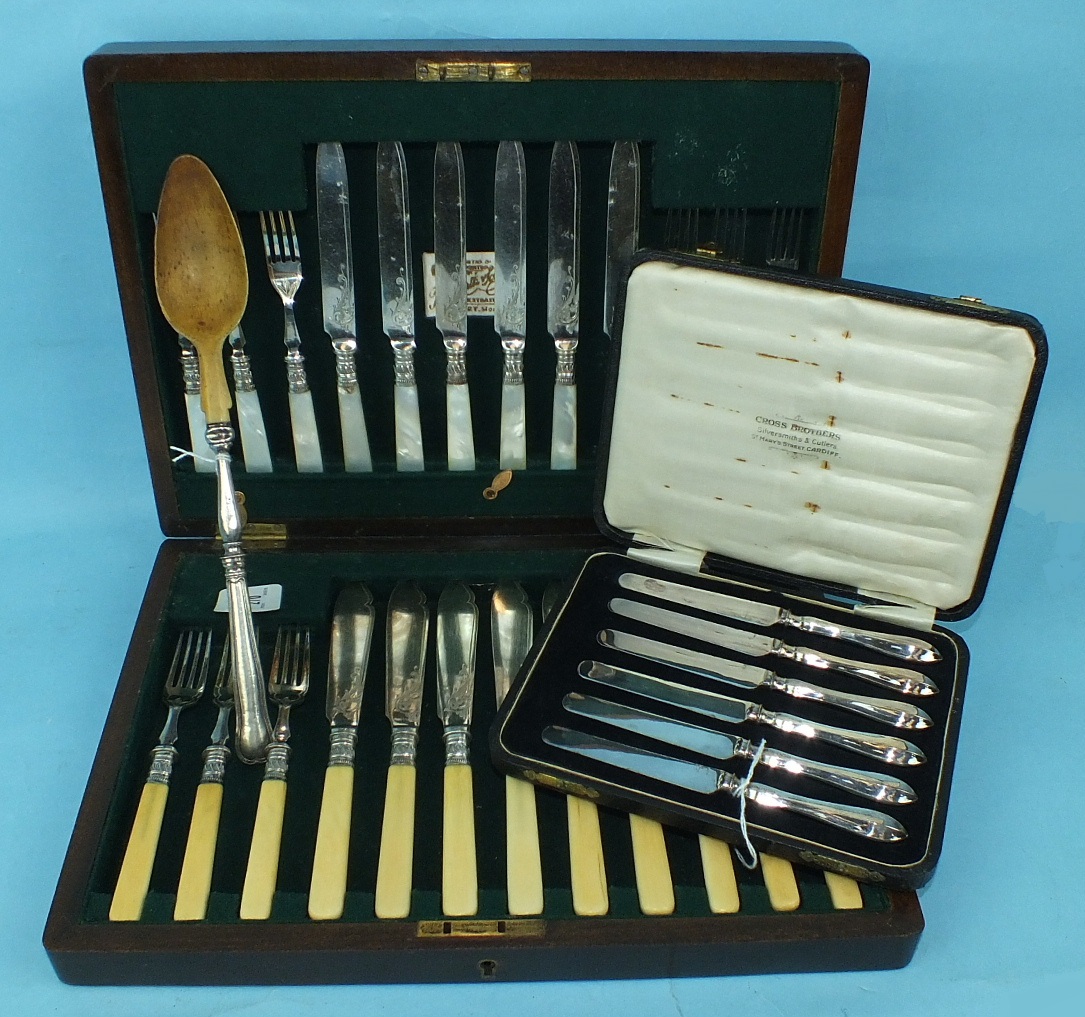 A set of six each mother-of-pearl-handled dessert knives and forks, a set of fish eaters in case,