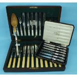 A set of six each mother-of-pearl-handled dessert knives and forks, a set of fish eaters in case,